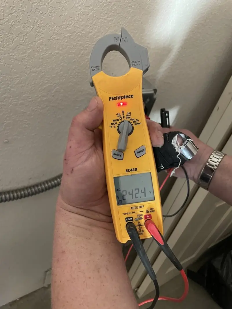 Voltage testing with clamp meter during Outlet Installation in Upper Yoder